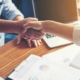 Business People giving a Handshake, making a Deal at work