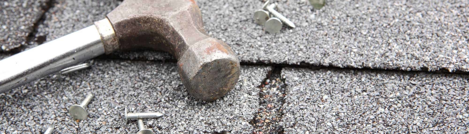 Hammer and nails on top of roof