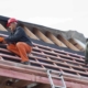 Roofers installing roof structure