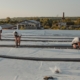 Image of workers repairing a commercial roof.