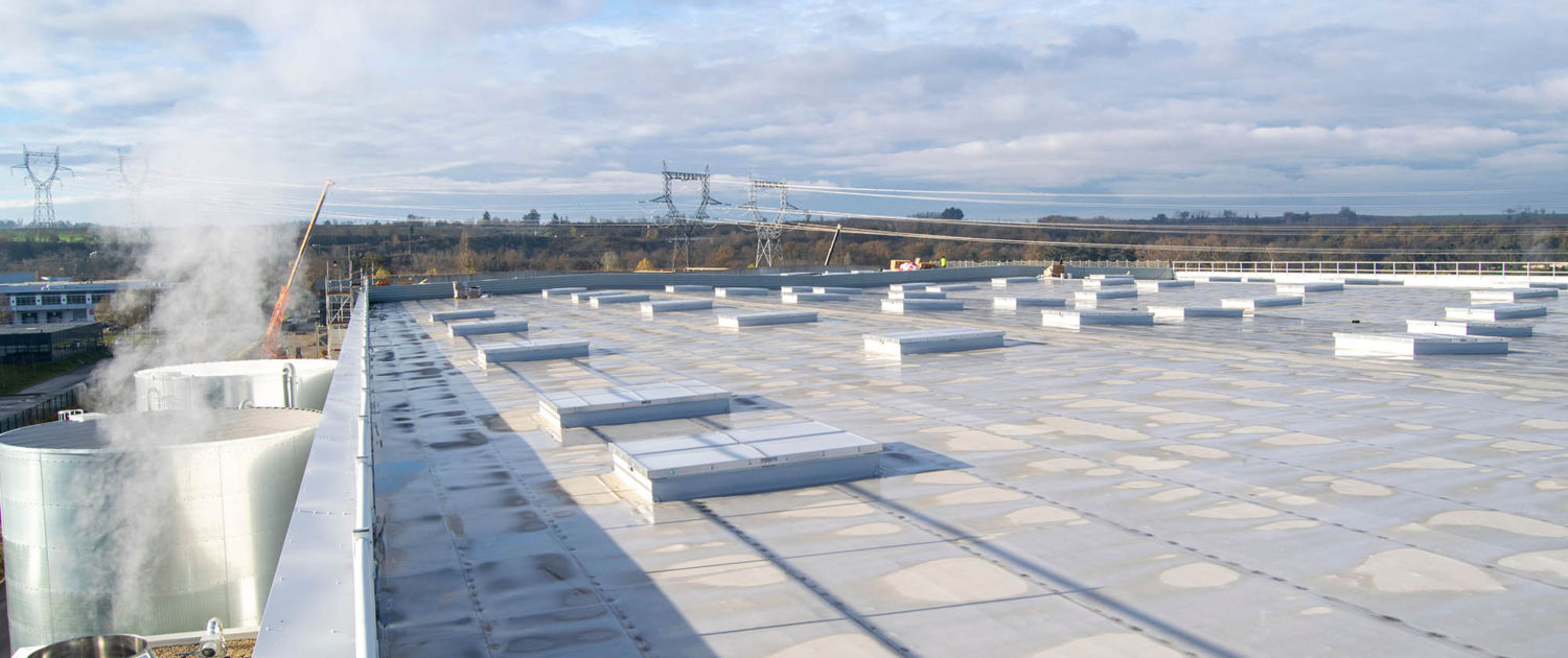 Side view of a large white commercial roof