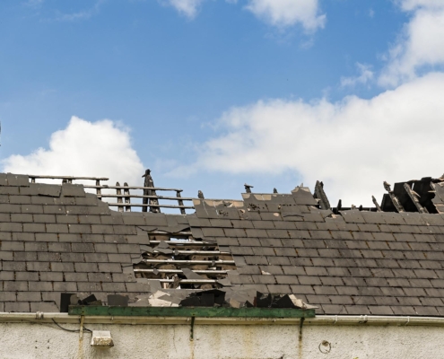 A commercial roof that has taken significant damage