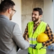 Business person shaking hands with roofer