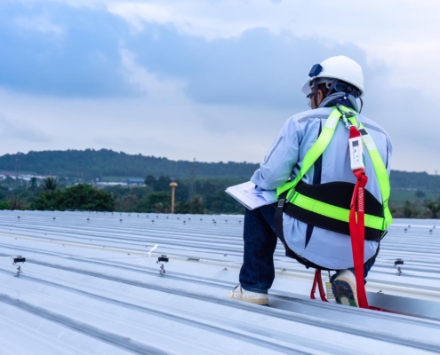 Professional inspecting commercial roof