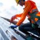 Roofer working on roof structure of building on construction site
