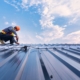 worker repairing metal roof