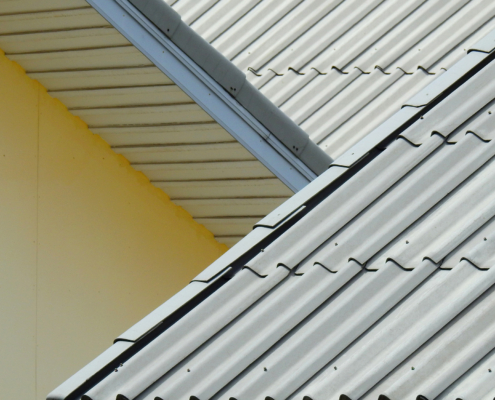 Side view close up of metal roof shingles on residential or commercial building
