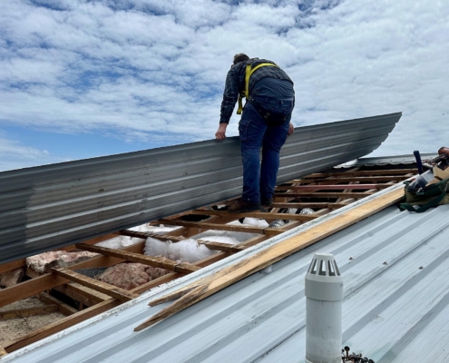 Worker installing new metal roof