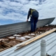 Worker installing new metal roof