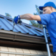 metal roofing - roofer working on the house roof