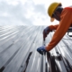 Worker installing metal roof