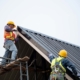 workers installing new metal roof