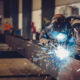 Welder joining steel beams together_